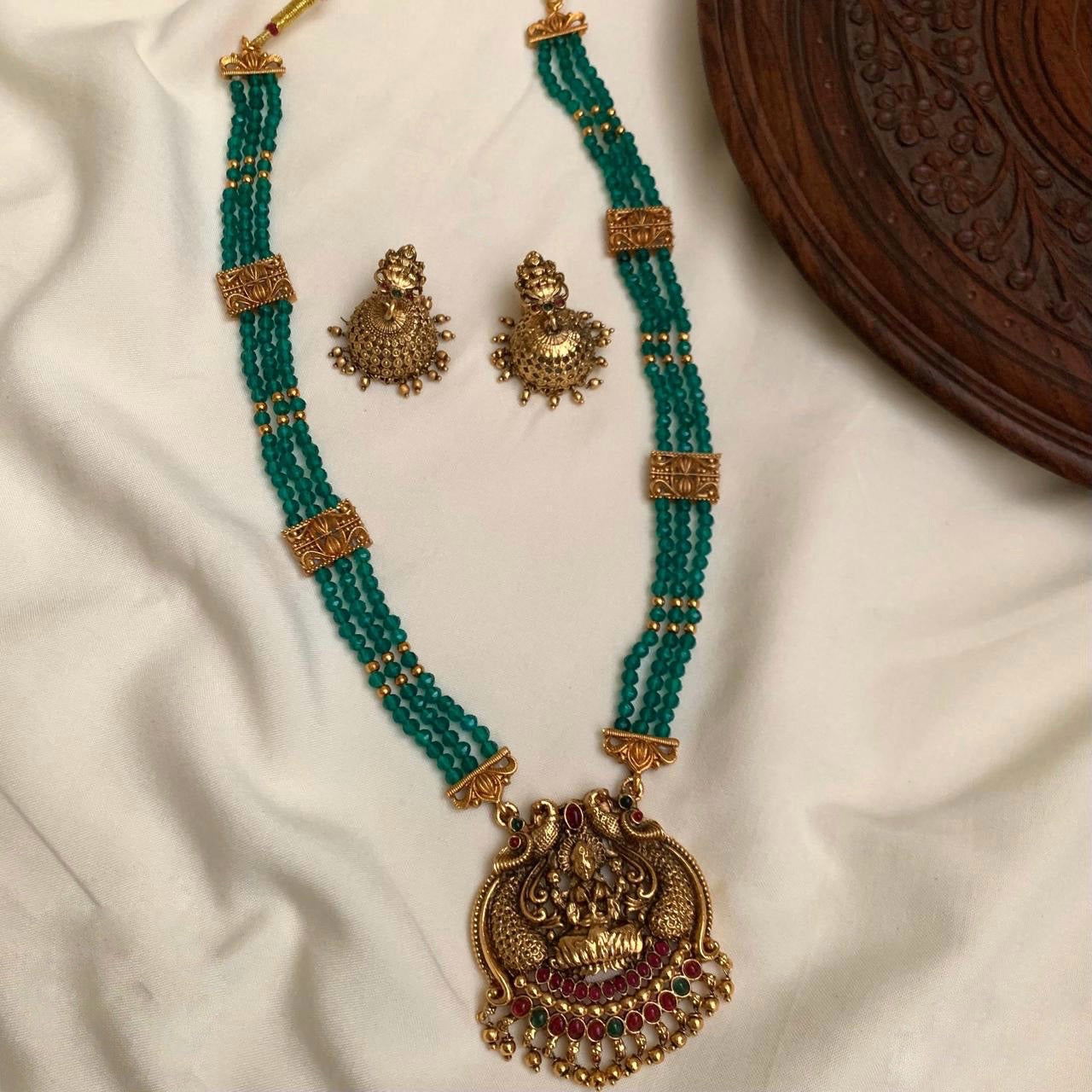 Green beads with gold drops haram